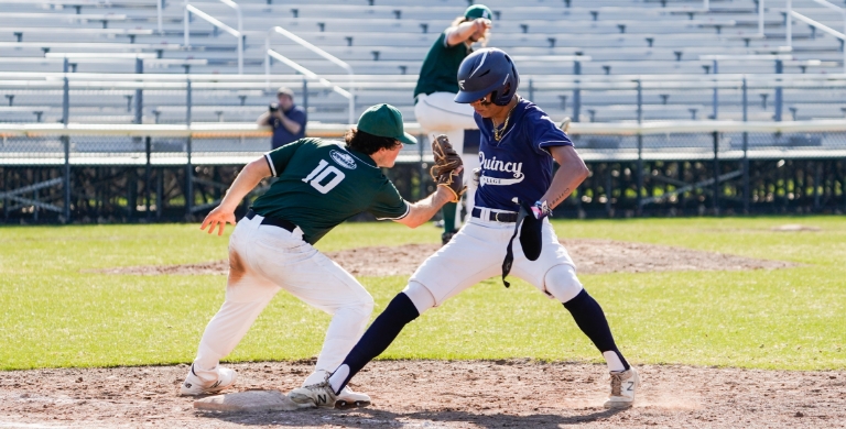 two Quincy College students playing baseball