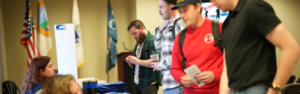 Quincy College's staff welcoming student at Veterans Celebration