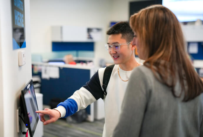 Prospect student pointing to a screen