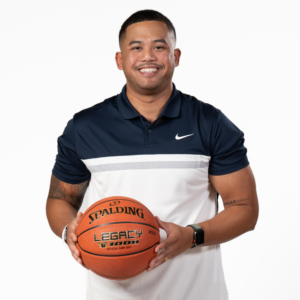 Associate Head Coach Kenny Nguyen holding a basketball