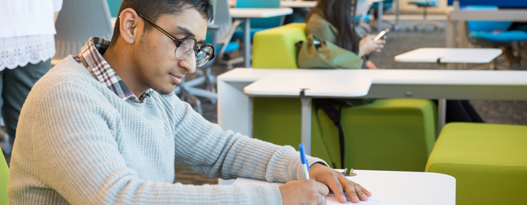 Male student studying in the library