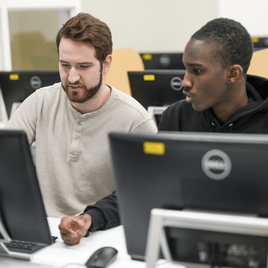 Two mans are working on computer