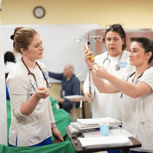 Three doctors are examining a patient.